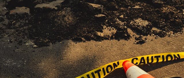 A cone and caution tape around a what represents fertility destruction.