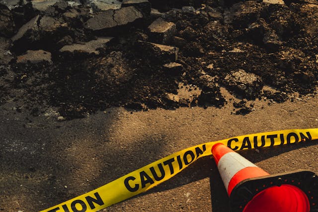 A cone and caution tape around a what represents fertility destruction.